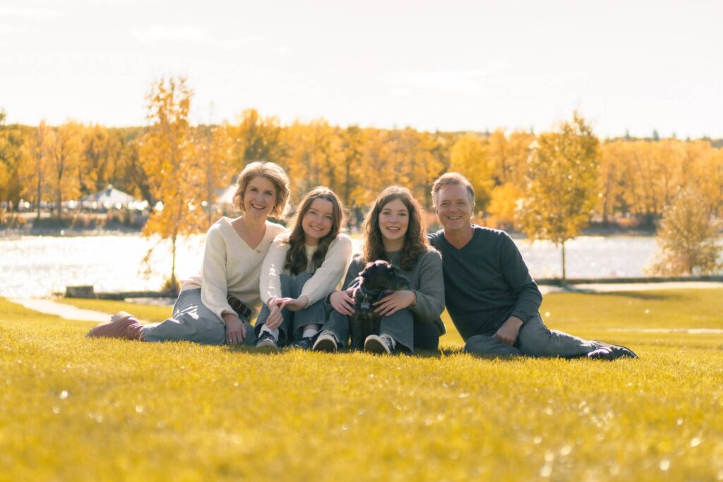 Family enjoying autumn colours at Baker Park Calgary