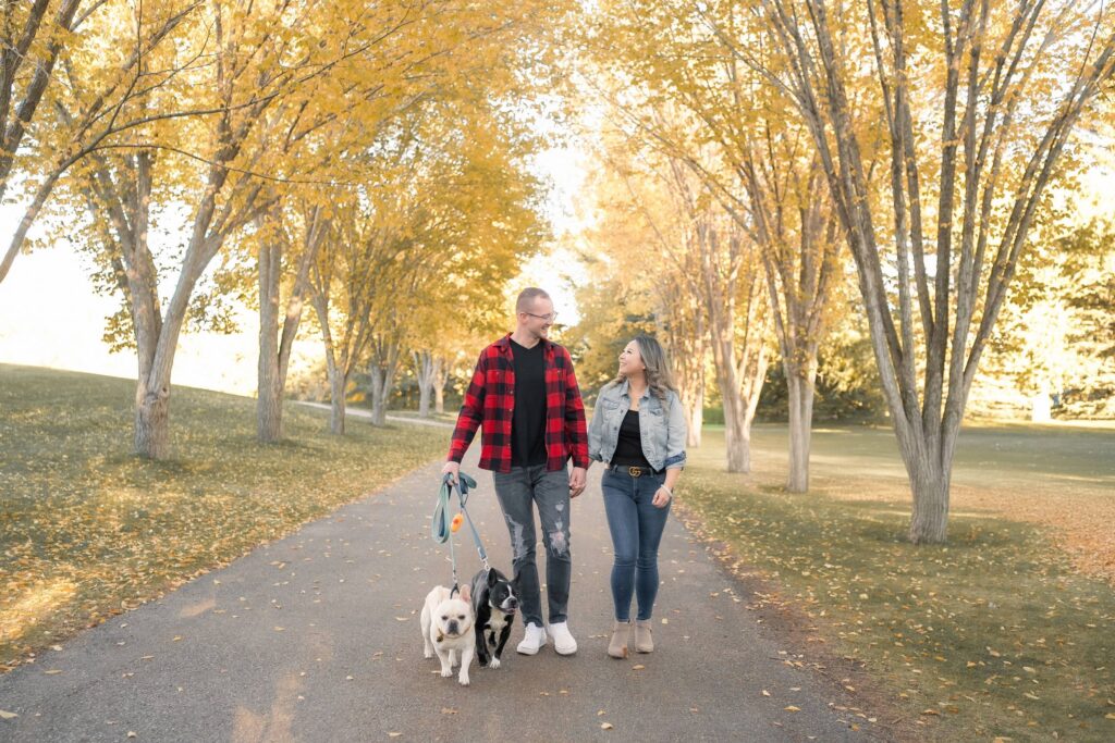Couple enjoying a fall photo session at Baker Park Calgary